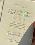 Wedding invitation card held by a hand with a neutral background