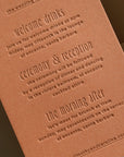 Brown leather wedding invitation with embossed text