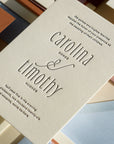 Wedding invitation card with 'carolina & timothy' on a colorful background