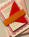 Invitation card with red envelope on a beige background