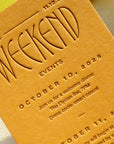 Invitation card with embossed text on a yellow background