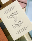 Wedding invitation card with 'carollina & timothy' on a colorful background