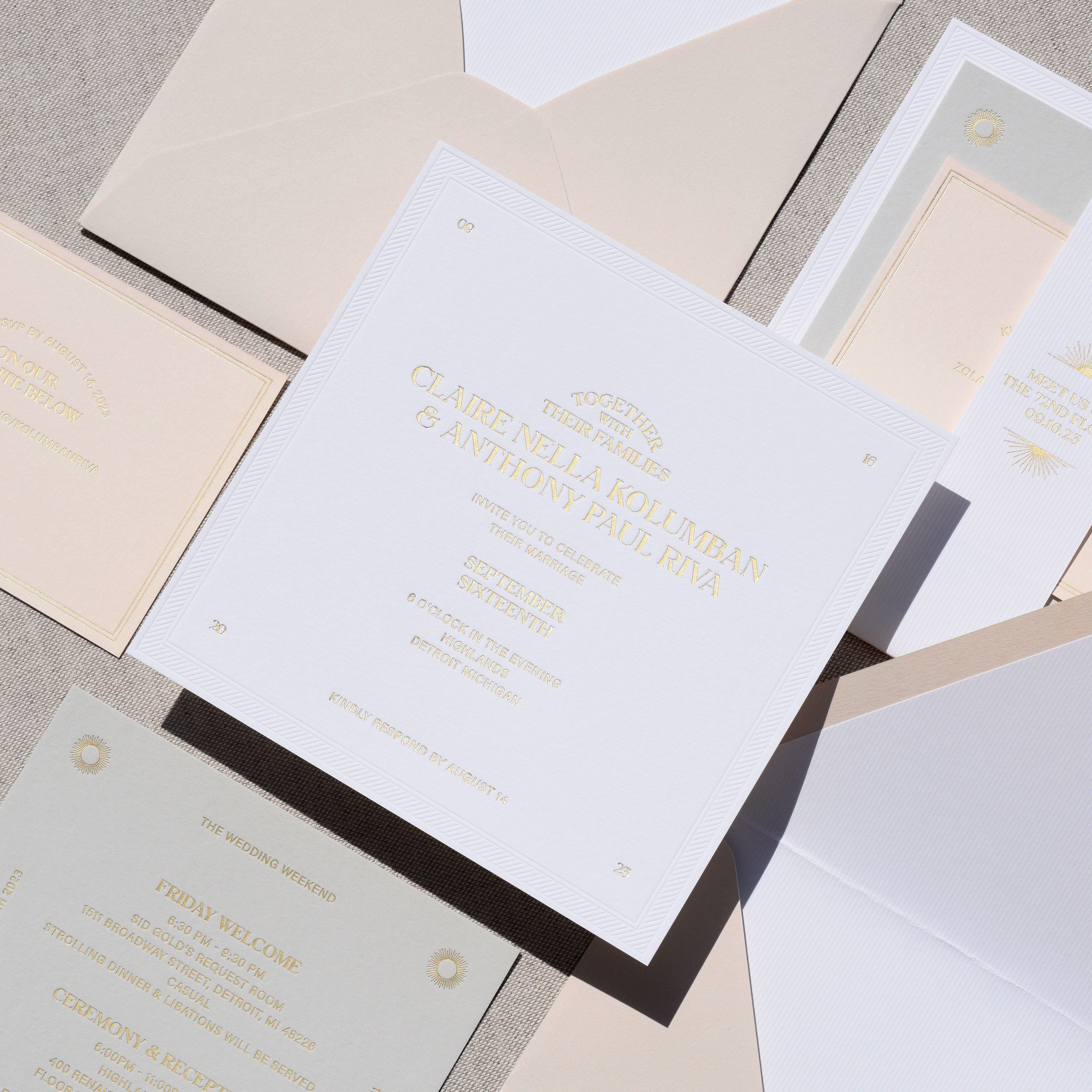 Invitation card with gold text on a gray surface