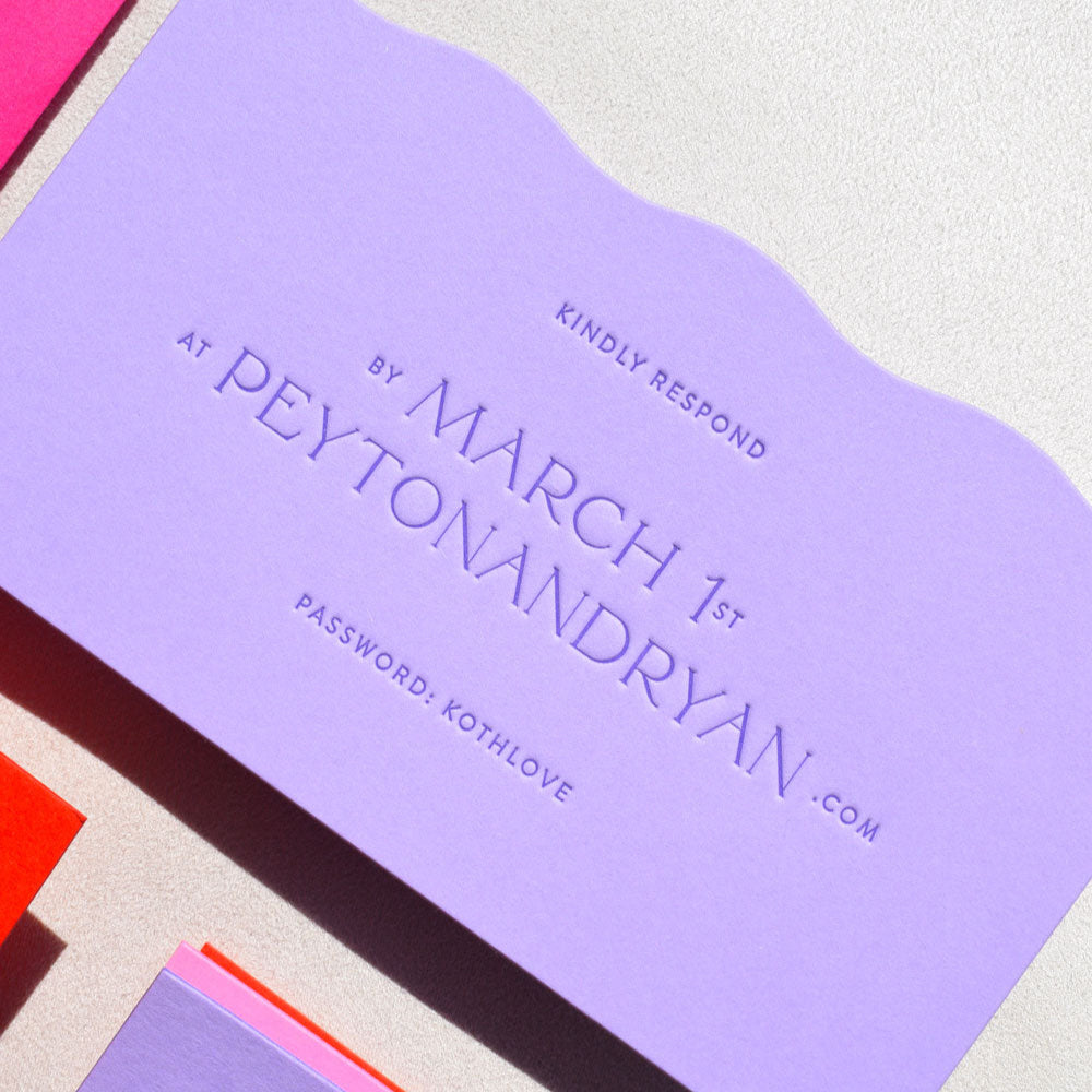 Purple card with text and a pink envelope on a light gray background