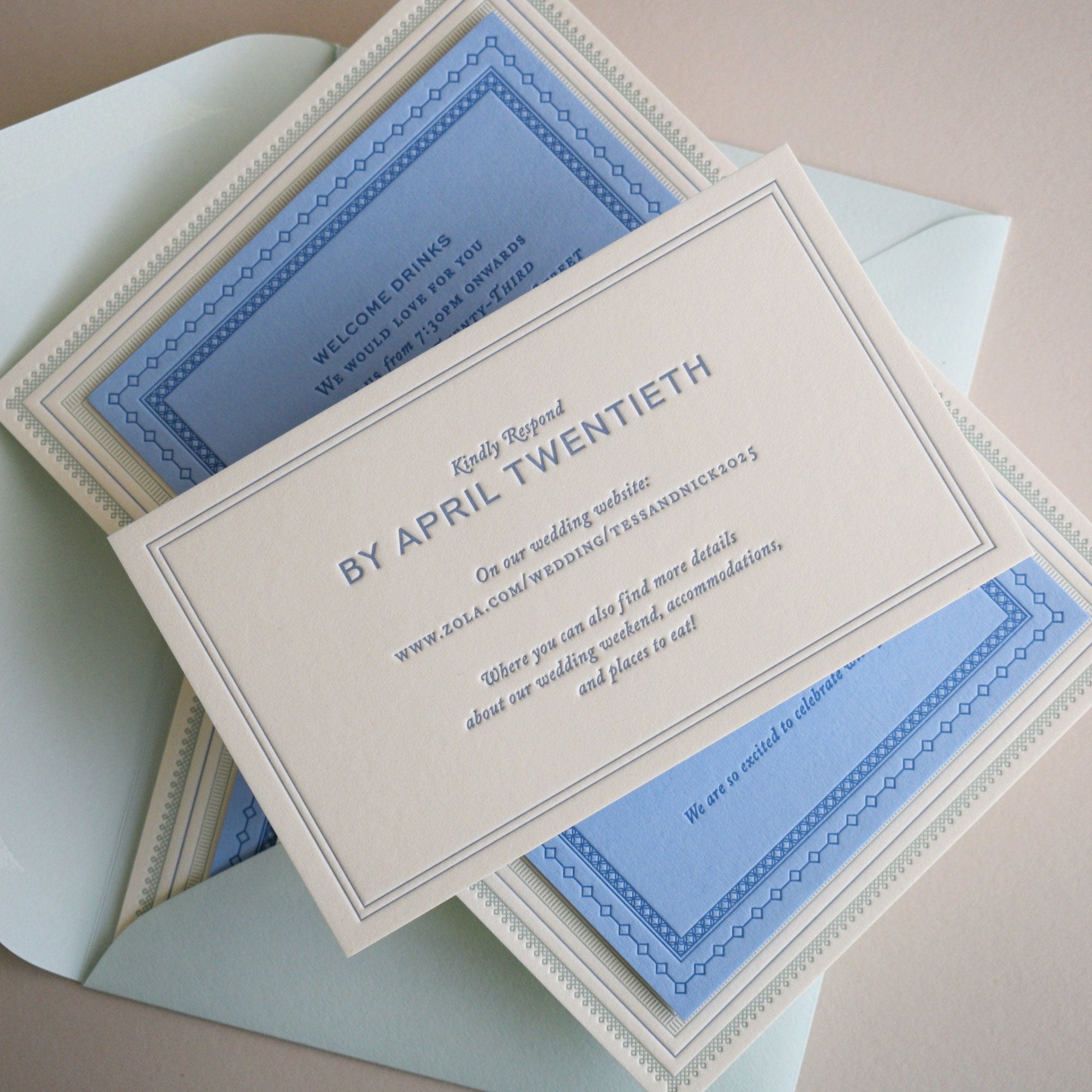 Wedding invitation card with blue and white design on a beige background
