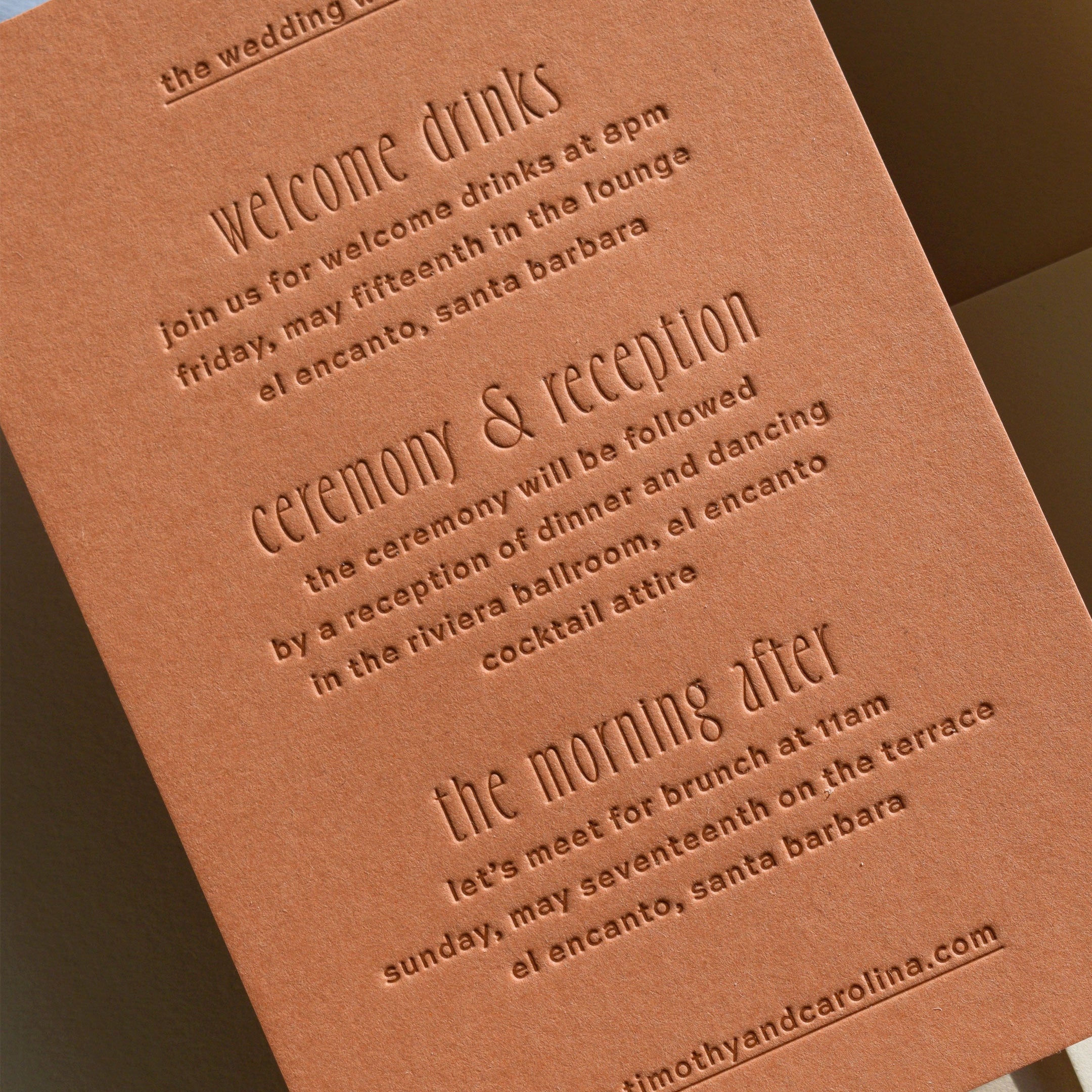 Brown leather wedding invitation with embossed text