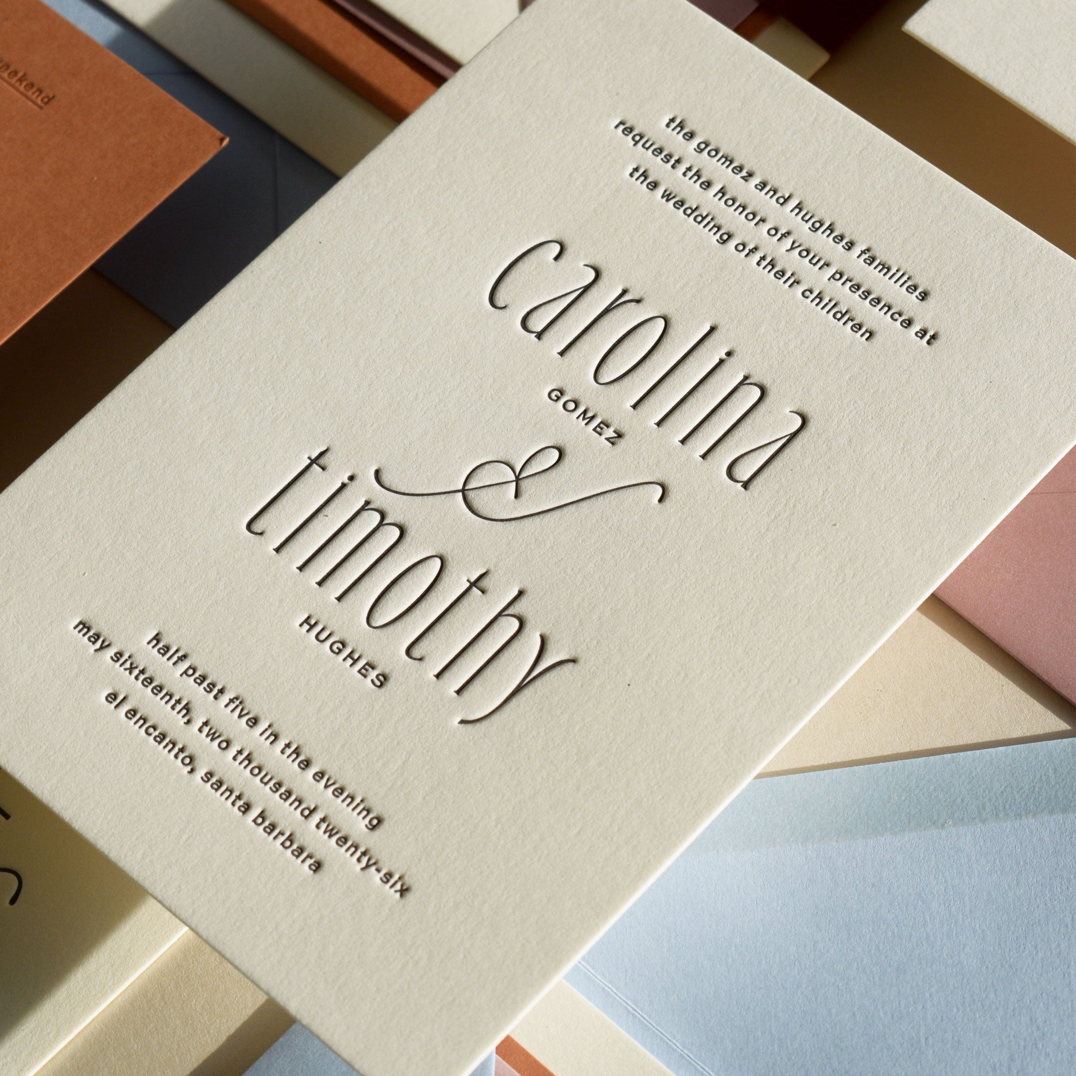 Wedding invitation card with 'carolina & timothy' on a colorful background