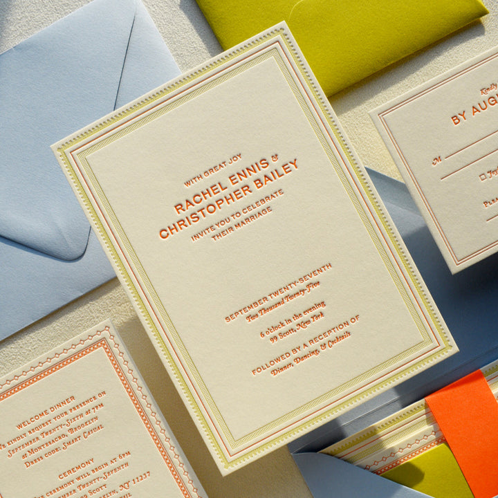 Wedding invitation cards with envelopes on a light surface