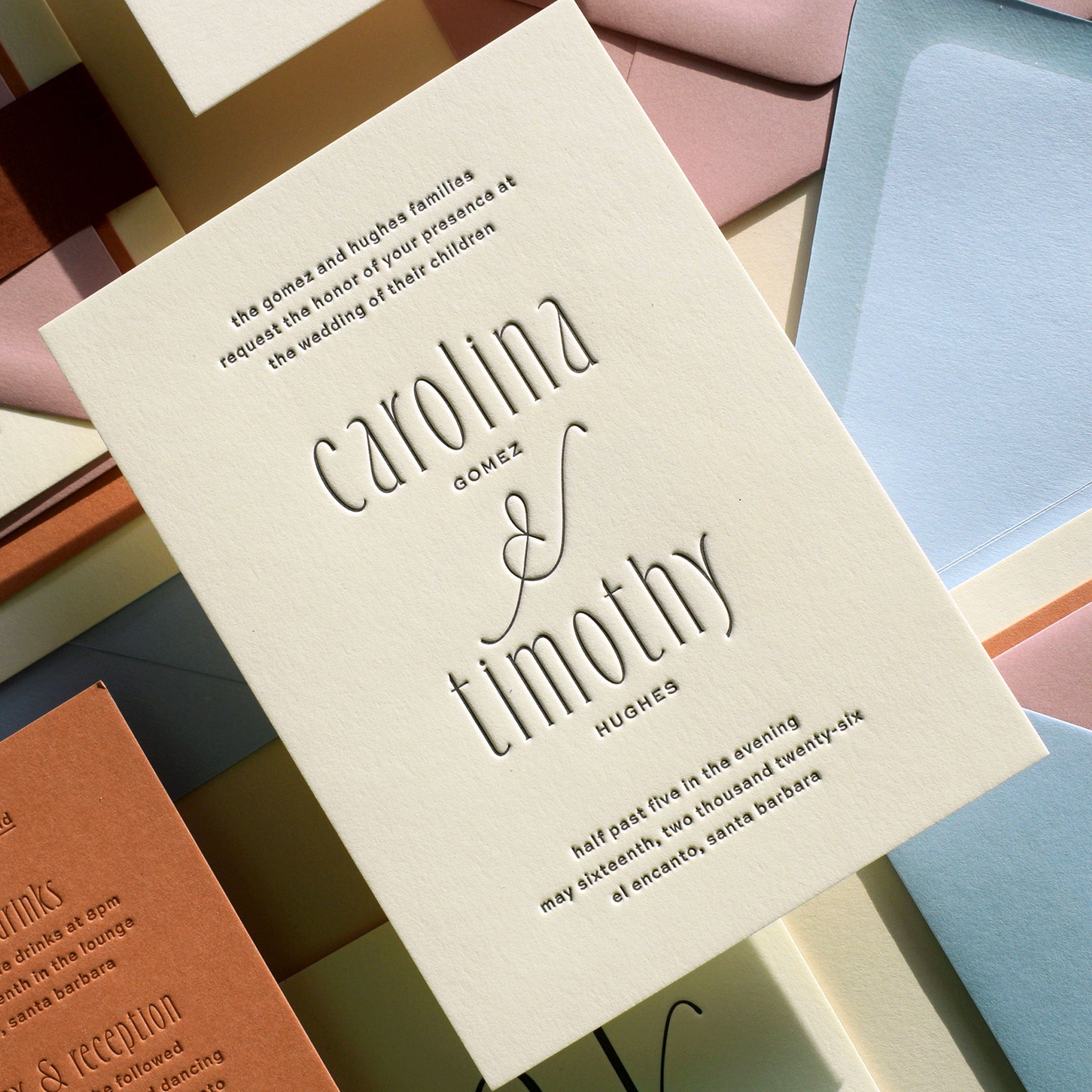 Wedding invitation card with 'carollina & timothy' on a colorful background